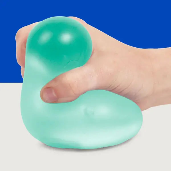 A hand squishes the Sea Glass Speks Gump Jumbo Gel Stress Ball.