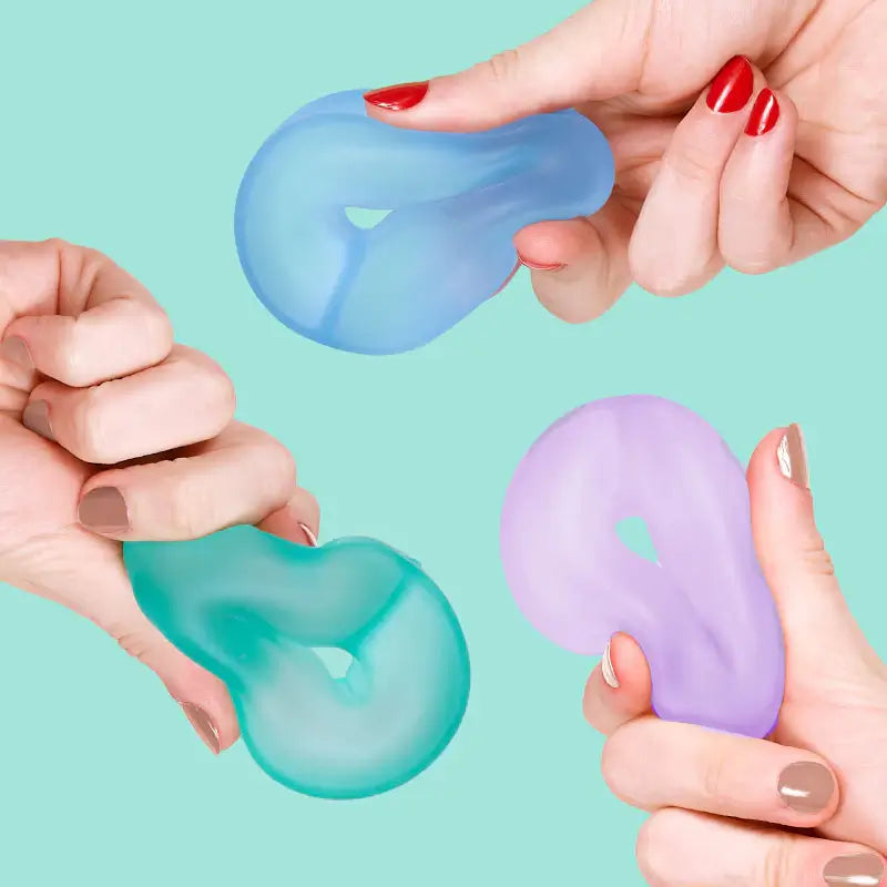 Three different hands squish and squeeze and three different colors of the Speks Gump Loop Cool 3-Pack.