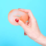 A hand squishes the Speks Gump Loop Gel Stress Ball.