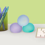 The Speks Gump Memory Gel Stress Balls - Cool 3-Pack on a desktop.