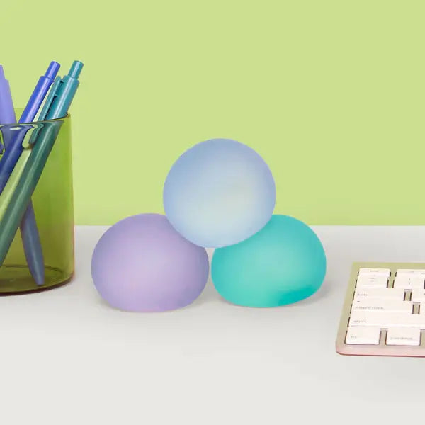 The Speks Gump Memory Gel Stress Balls - Cool 3-Pack on a desktop.