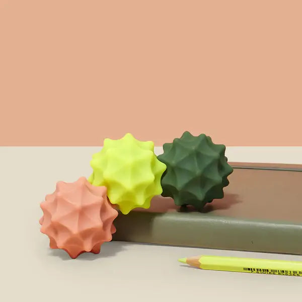 Speks Odds Vivid Green Spurs positioned cascading down a notebook.