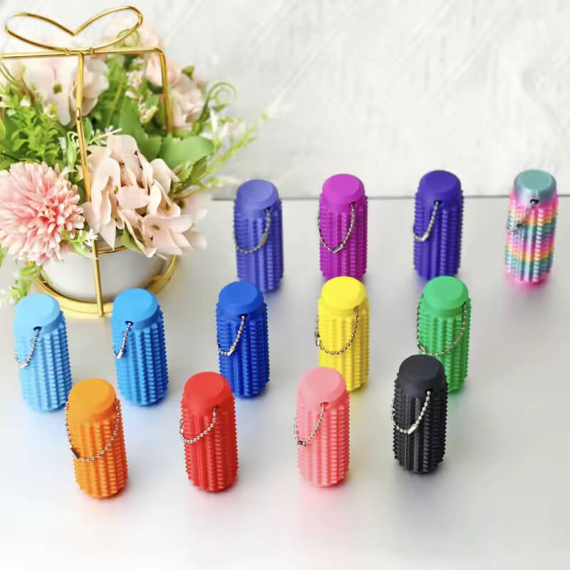 A mutlicolor spread of Spiky Tactile Sensory Keychains next to a bouquet.