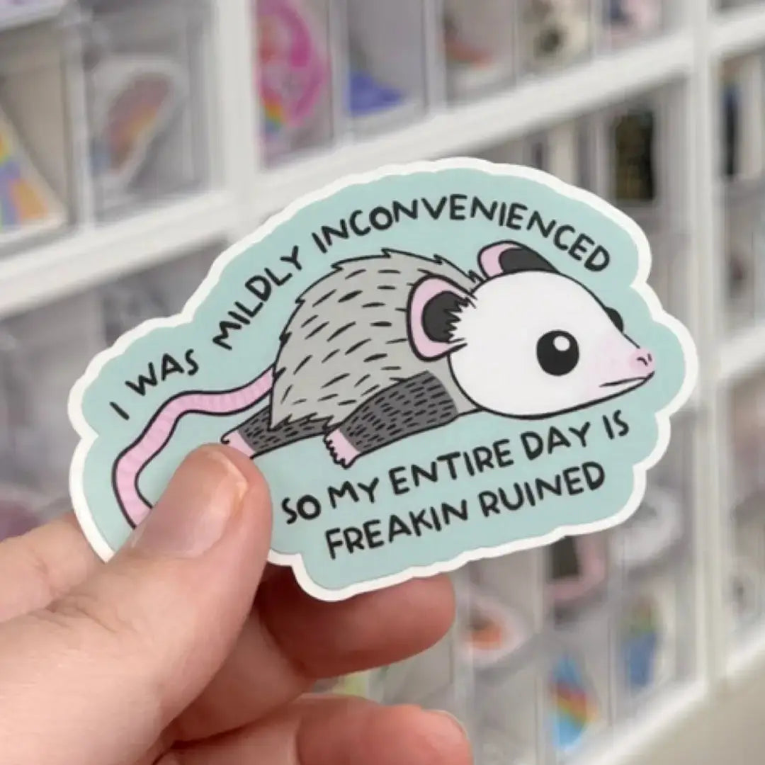 A possum lies flat with text that reads: I was mildly inconvenienced so my entire day was freaking ruined.