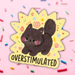 A cartoon cat with bright red cheeks looks stressed out and the text reads: Overstimulated.