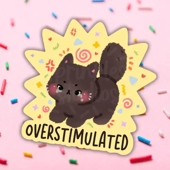A cartoon cat with bright red cheeks looks stressed out and the text reads: Overstimulated.