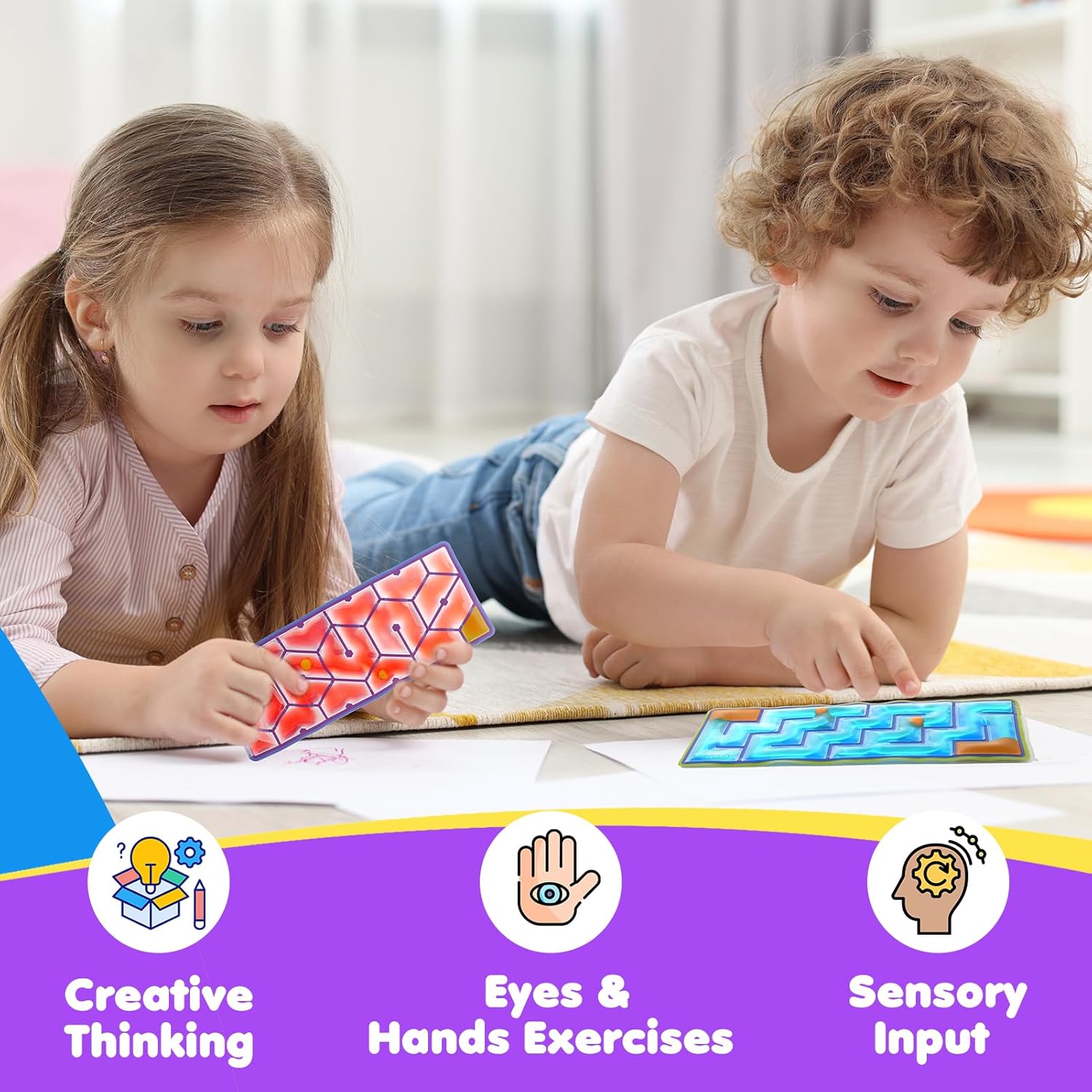 Two children lay on the floor, each with their own Squeezy Sensory Maze with rubber balls.