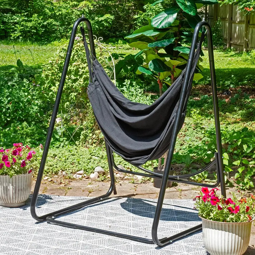 The Polycotton Hammock Chair with A-Frame Steel Stand outside on a patio.