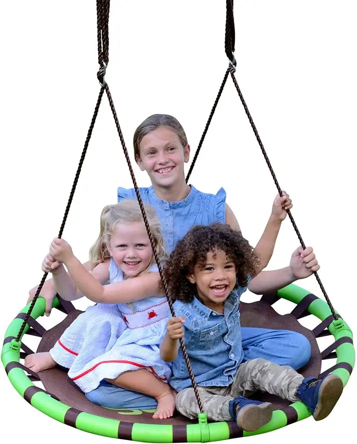 Three children smile as they swing on the Swurfer Orbit Tree Swing.