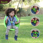 A toddler swings outside in the green Swurfer Kiwi Baby and Toddler Swing.