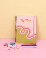 The Loop De Loop 2026-2027 Dated Academic Planner surrounded by paper clips and Jotter Pens.