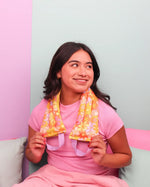 Woman wearing pink has the Really Pretty Florals Cooling Weighted Neck Wrap - 2 lb draped over her shoulders.