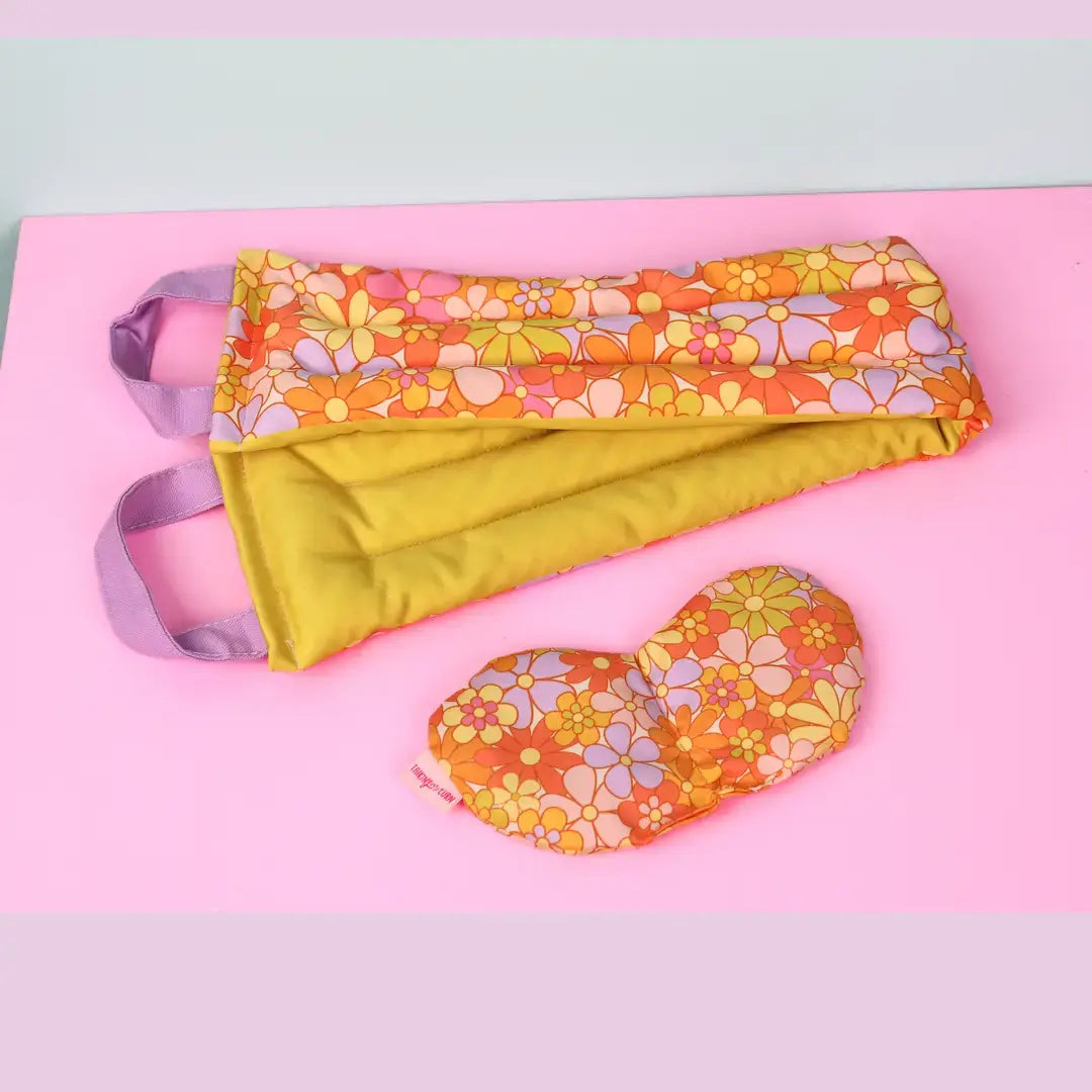THe Really Pretty Florals Cooling Weighted Neck Wrap - 2 lb next to an eye mask with the same pattern.