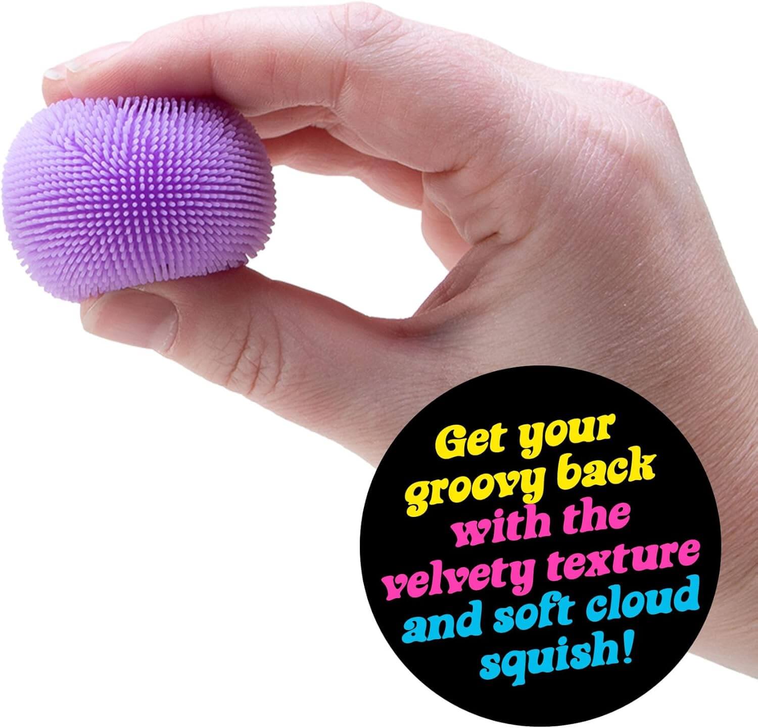 A hand squeezes a purple Teenie Nee Doh Fuzz Ball.