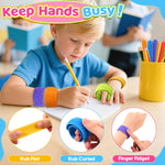 A child wears three Textured Silicone Sensory Slap Bracelets and holds one on a finger while they write something on a pad of paper during class.