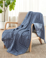 The Dusk Baloo Mini Weighted Blanket draped over a chair.