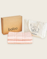 The Petal Pink Baloo Mini Weighted Blanket with the free tote and box that it is shipped in.