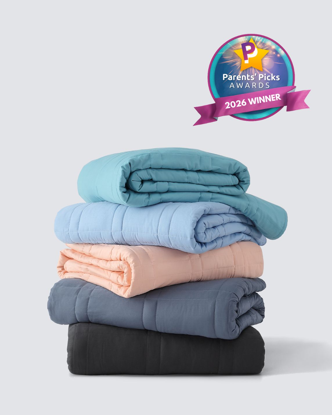 A stack of five different colors of the Baloo Mini Weighted Blankets.