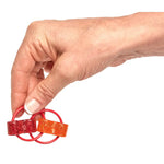 A hand holds the smaller Loopez Jr.