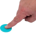 A hand presses down on a blue nubbed Silicone Zen Raised Dot.
