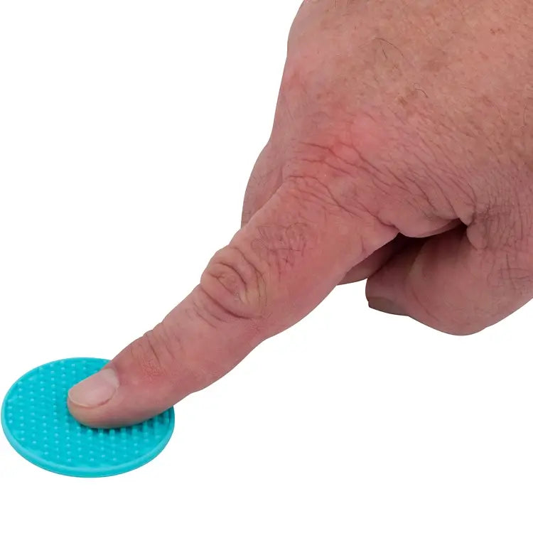 A hand presses down on a blue nubbed Silicone Zen Raised Dot.