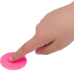 A finger presses down on a pink nubbed Silicone Zen Raised Dot Sensory Sticker.