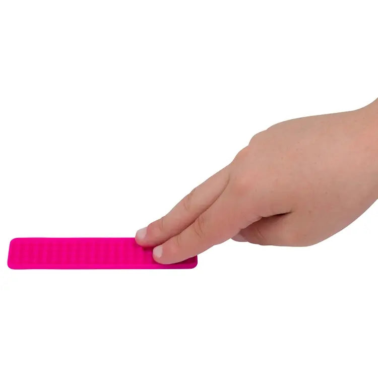 A hand touches the texture on the pink Silicone Zen Raised Strip Sensory Sticker.