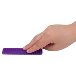 A hand touches the purple textured Silicone Zen Raised Strips Sensory Sticker.