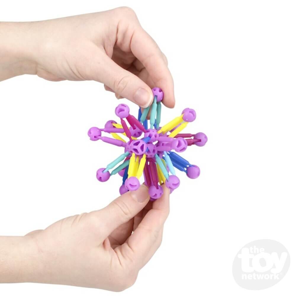 Two hands press the 3" Mini Collapsible Ball closed.