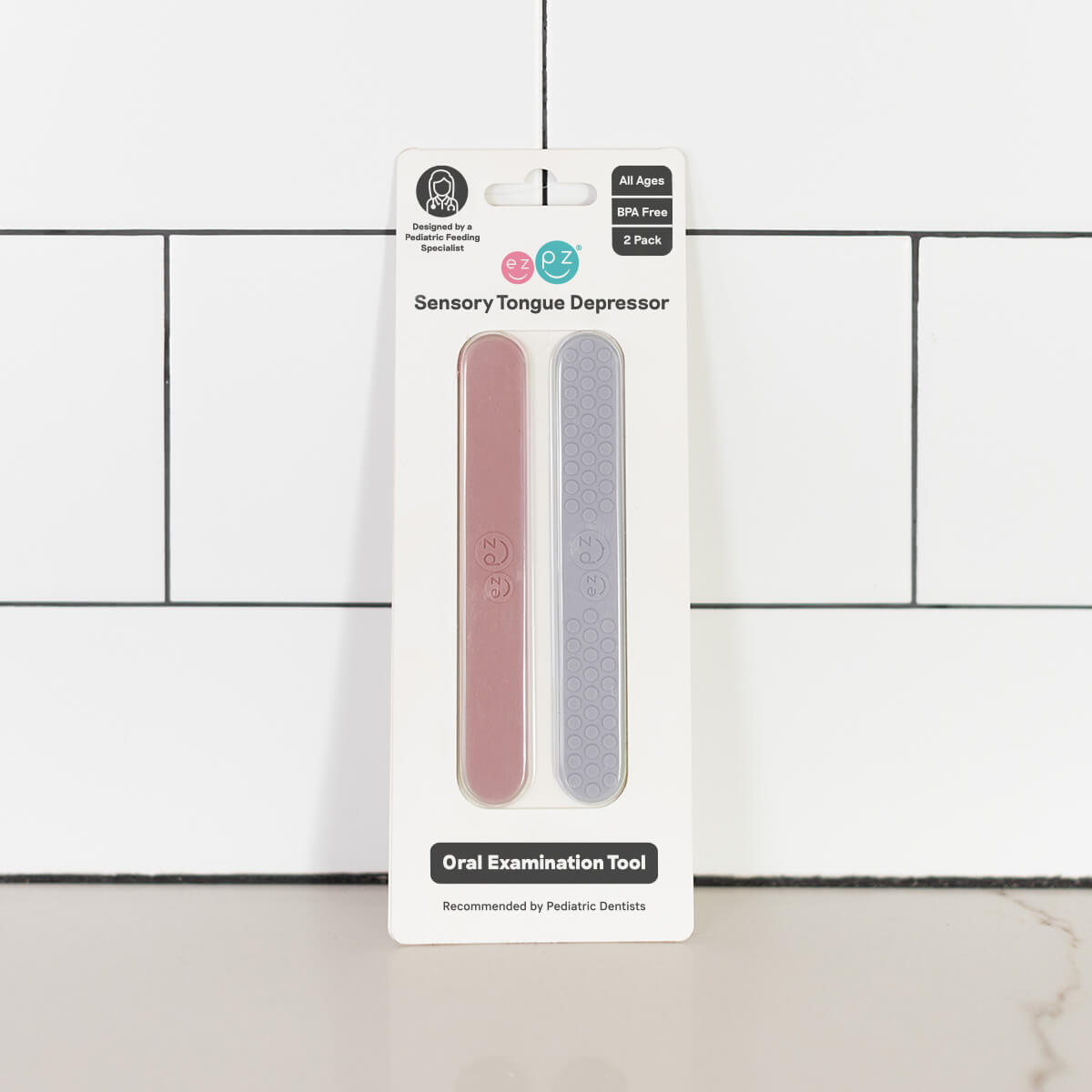 The Blush and Pewter Tongue Depressor Set in its product package.