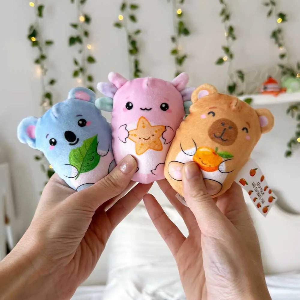 Two hands hold up three different Bubble Stuffed Squishy Friends - Emotional Support Edition.