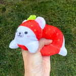 A white bear dressed up as a strawberry Sand-A-Roo.