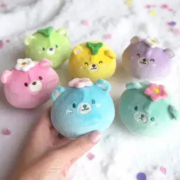 A hand holds up a blue Sno-Chi Squishy.