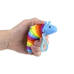 A hand holds the blue 3.75" Sensory Wiggle Caterpillar Clip On.
