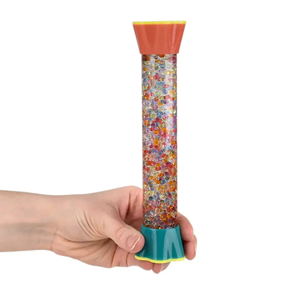 A hand holds the8" Water Bead Sensory Tube while the beads rise to the top.