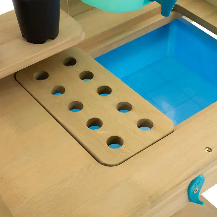 A close-up of the TP Toys Wooden Explore Potting Bench Outdoor Playset.