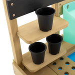 A close-up of the shelves and pots that come with the TP Toys Wooden Explore Potting Bench Outdoor Playset.
