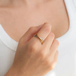A hand models the Tri-Color Dainty Interlocking Fidget Ring. 