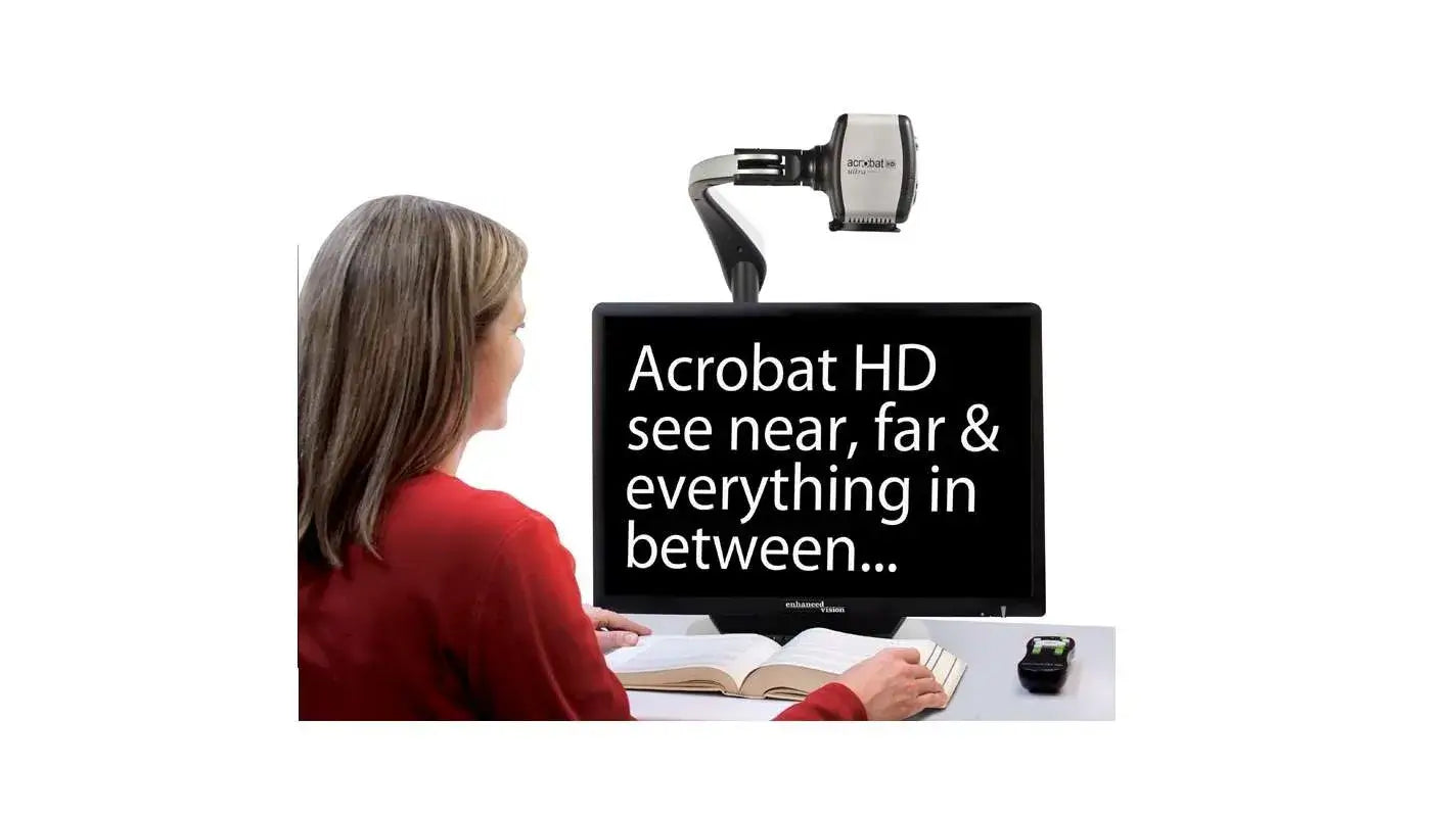 A woman sits in front of the Acrobat Ultra HD Low Vision Magnifier, which is magnifying a piece of text from a book that is open in front of her.