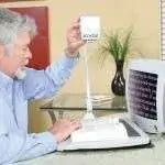 A man adjusts a screen reader on the Full Size XY Table.