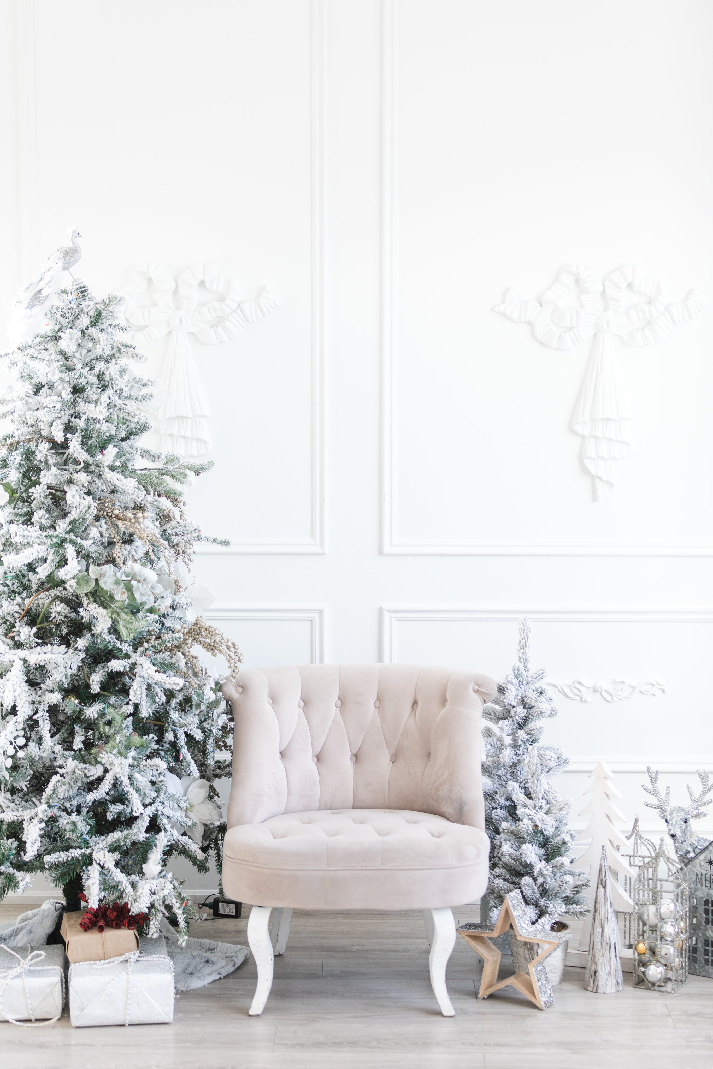 White room with a white chair and white christmas decorations