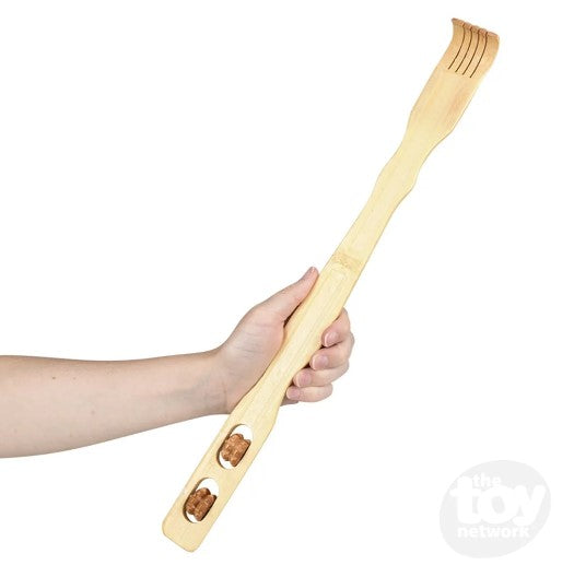 A forearm with light skin tone holds up the Wooden Back Scratcher with Massage Roller.