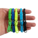 Five of the colorful Zipper Bracelet Fidgets are displayed on an adult hand.