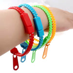 Four of the colorful Zipper Fidget Bracelets are displayed on a child's wrist.