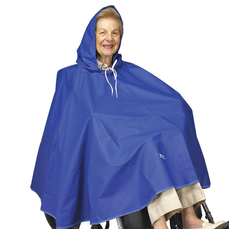 An older adult with light skin tone and covered blonde hair sits in a wheelchair, obscured by the Skil-Care Wheelchair Rain Cape.