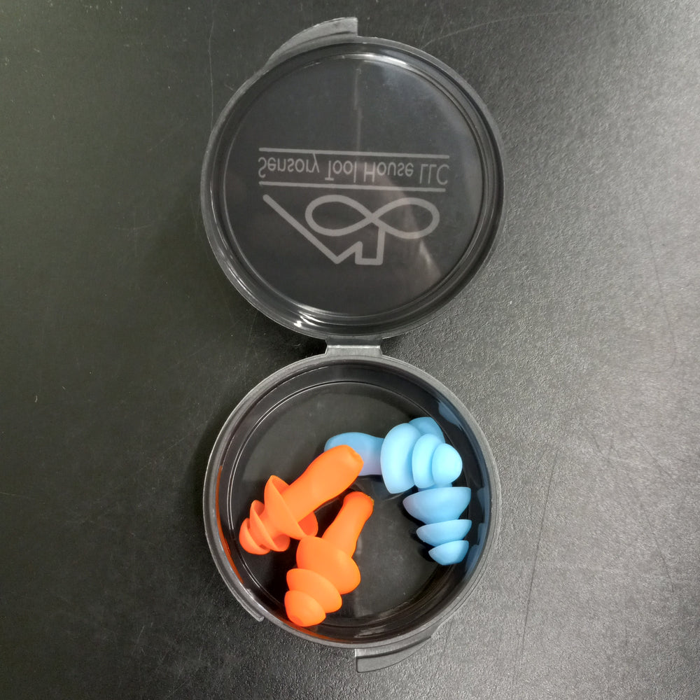 Looking down on the open case of the Sensory Tool House Limited Edition Noise Reducing Ear plugs with the blue and orange pairs of ear plugs inside.