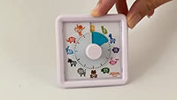 A hand touches the corner of the Animal Timer.