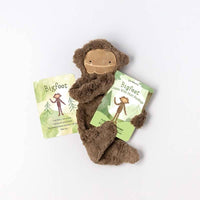 Slumberkins Maple Bigfoot Snuggler with the accompanying board book and affirmation card.
