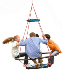 Four children sit on the Vortex Ring Swing while in motion.