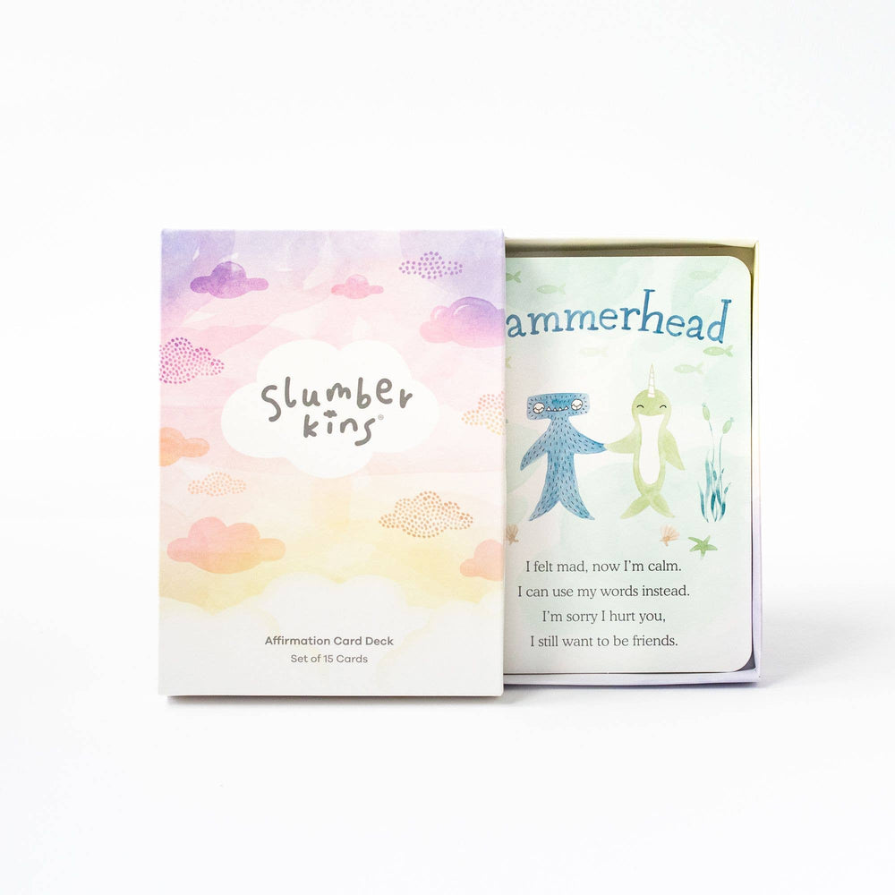 The cover of the box of Slumberkins Affirmation Cards open, revealing a look at one of the cards.